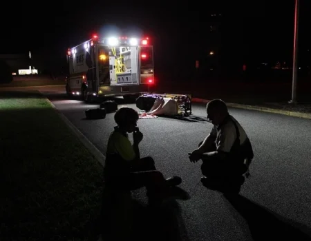 Emergency responders comforting a distressed person at night