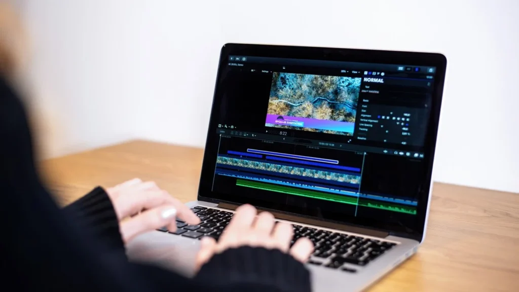 Person using video editing software on a laptop to edit vlog footage