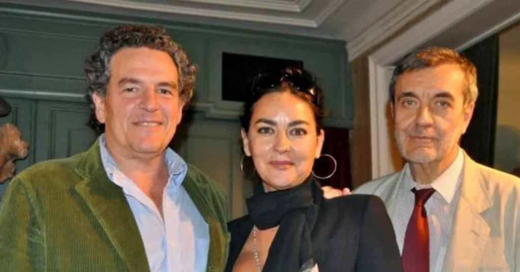 Carlos Scola Pliego attending a cultural event, engaging with fellow artists and guests in a vibrant, elegant setting.