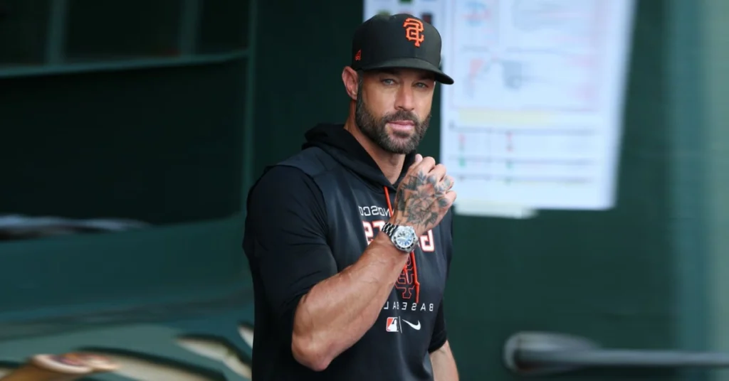 Gabriel Kapler in San Francisco Giants uniform watching from the dugout, showcasing the analytical mindset that led him from manager to Marlins executive