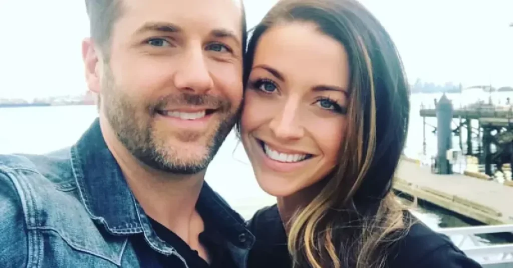 Matter Sara standing outdoors by a waterfront with Niall Matter, both smiling and enjoying a relaxed, candid moment together