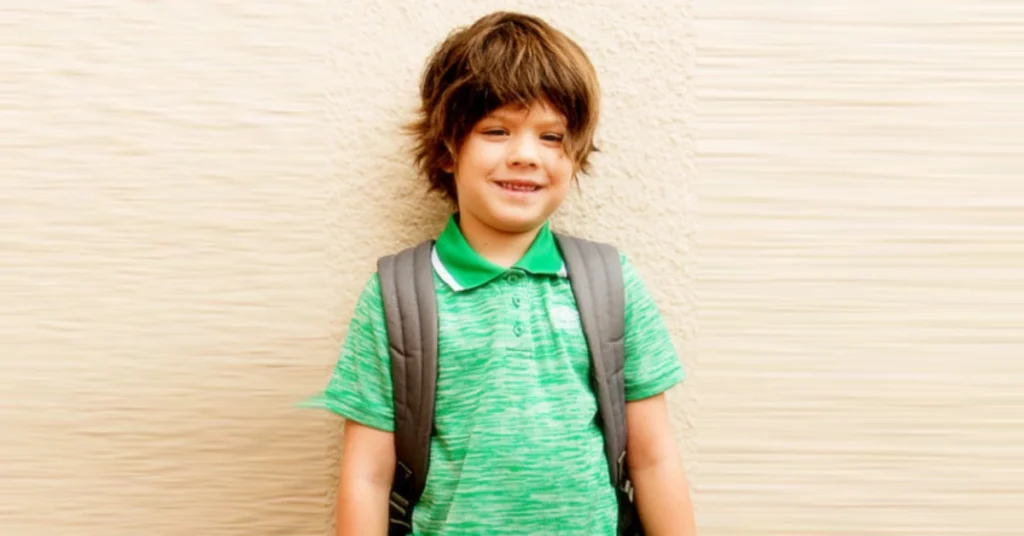 Thomas Colton Padalecki smiling in a green polo shirt with backpack, representing the eldest son of Jared and Genevieve's grounded celebrity family upbringing