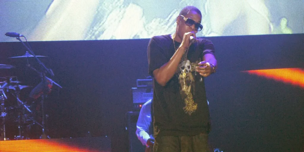 Inside Jay-Z’s $2.8 Billion Fortune: Champagne, Cognac and Smart Equity Deals Jay-Z net worth story: Jay-Z performing on stage with a microphone